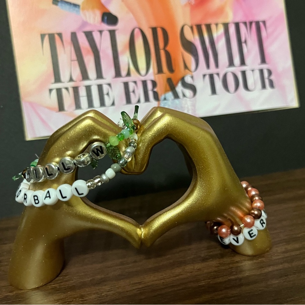 Taylor Swift Gold Hand Heart Jewelry Display with Beaded Bracelets